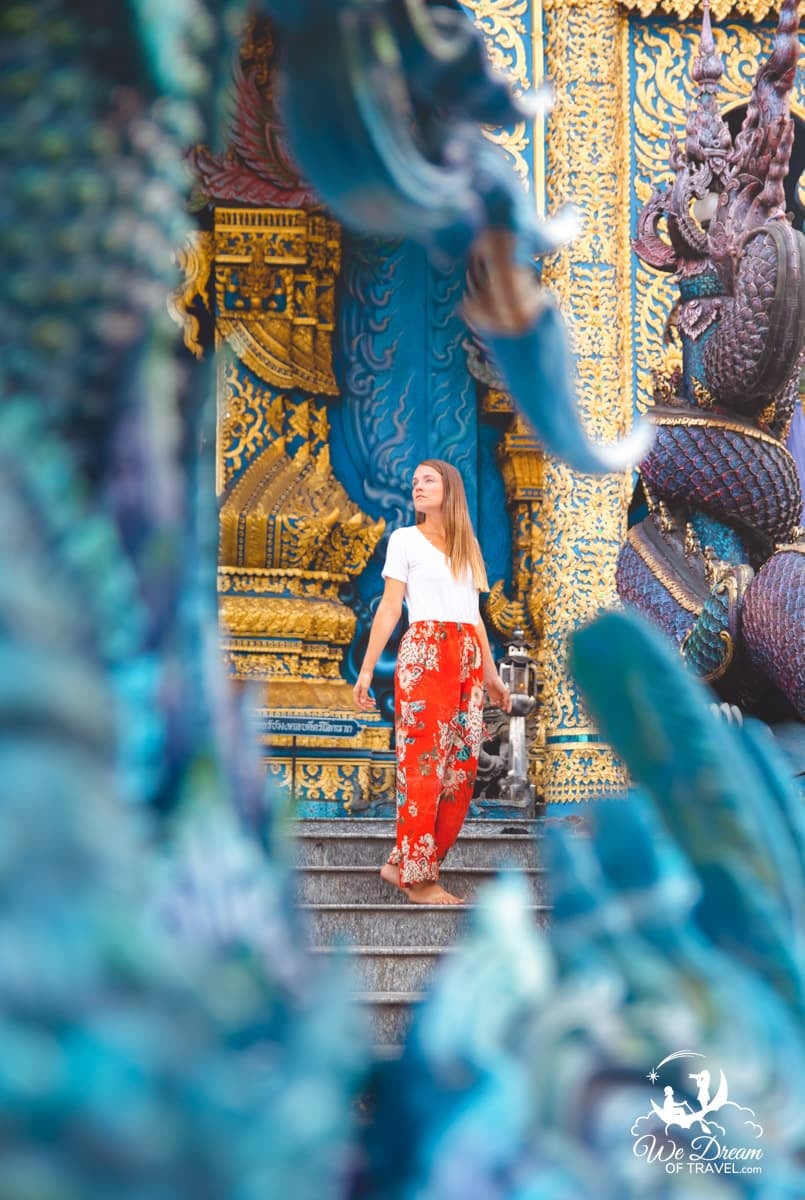 A girl poses for a photo at the Blue Temple in Chiang Rai, Thailand.