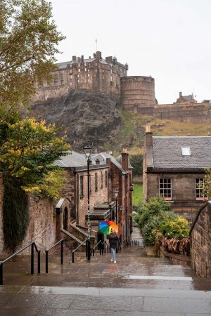 A young girl with a colorful rainbow walks up the steps of the Vennel in Edinburgh.