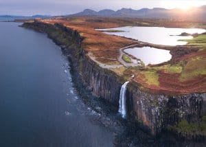 A drone shot reveals the landscape from high above Kilt Rock on the best Scotland road trip itinerary.