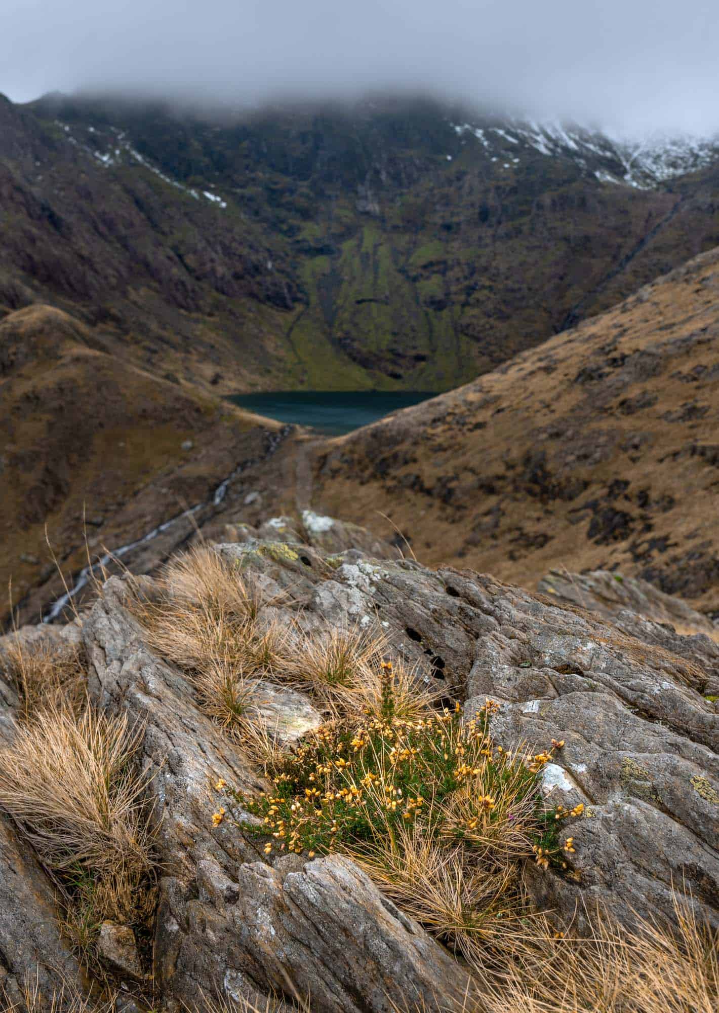 Snowdown Peak is hiding behind thick clouds from the Pyg Track on a November Snowdonia Road Trip.