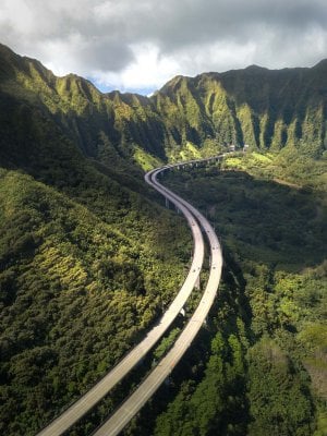 Drone Instagram photography of the H3 (Highway 3) seen cutting into the Koʻolau Mountains.