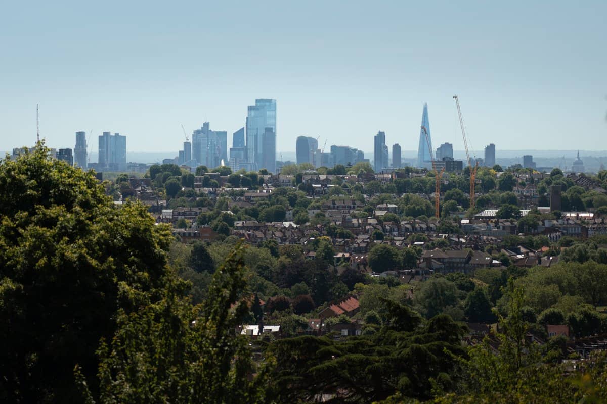 An alternative view of London from Alexandra Palace showing high rise buildings in the distance behind green neighbourhoods.