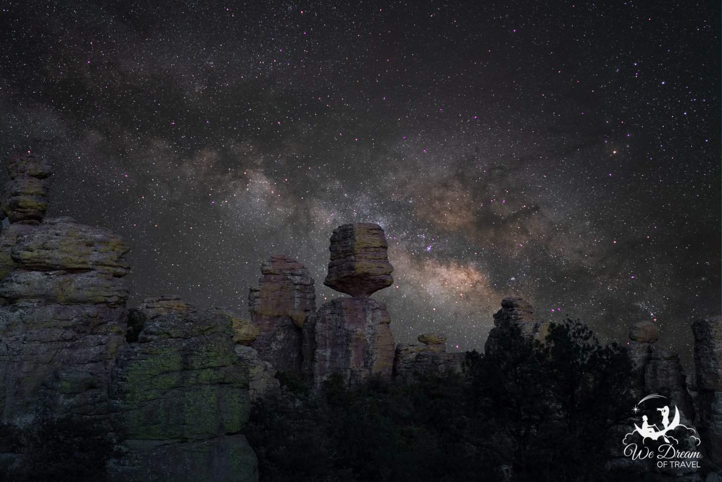 Big Balanced Rock teeters in the foreground with Milky Way rising behind.