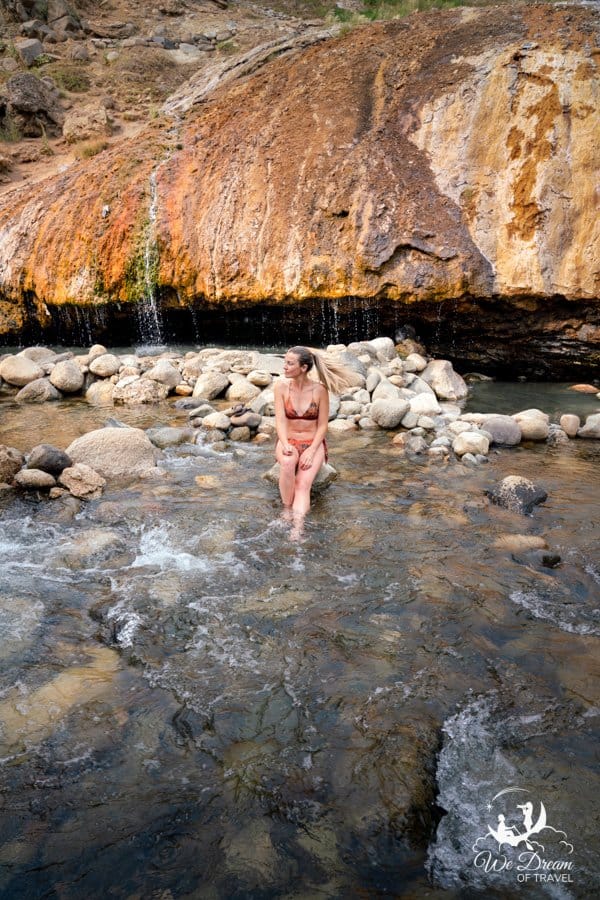 Warm water spills over travertine rock into the small pools of Buckeye Hot Springs.