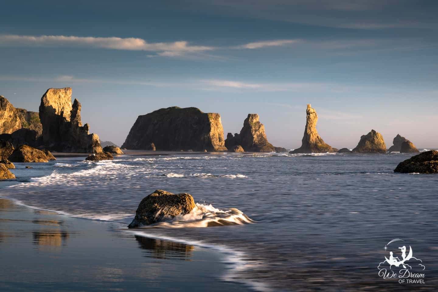 The towering seastacks of Bandon bathe in evening light.