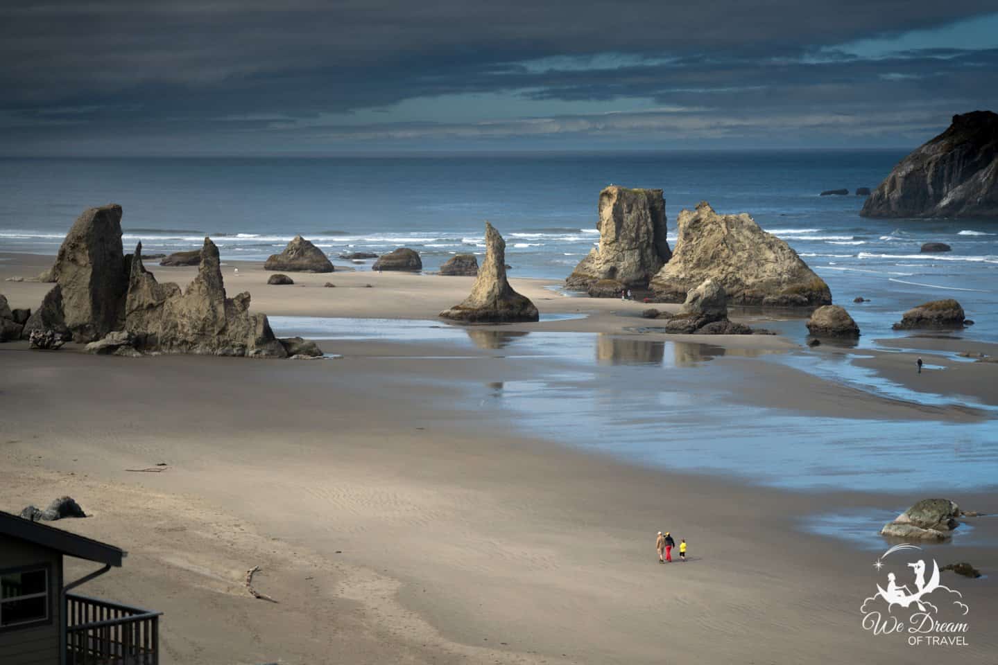 A family strolls across a forest of sea stacks along the beach at Bandon in Southern Oregon.