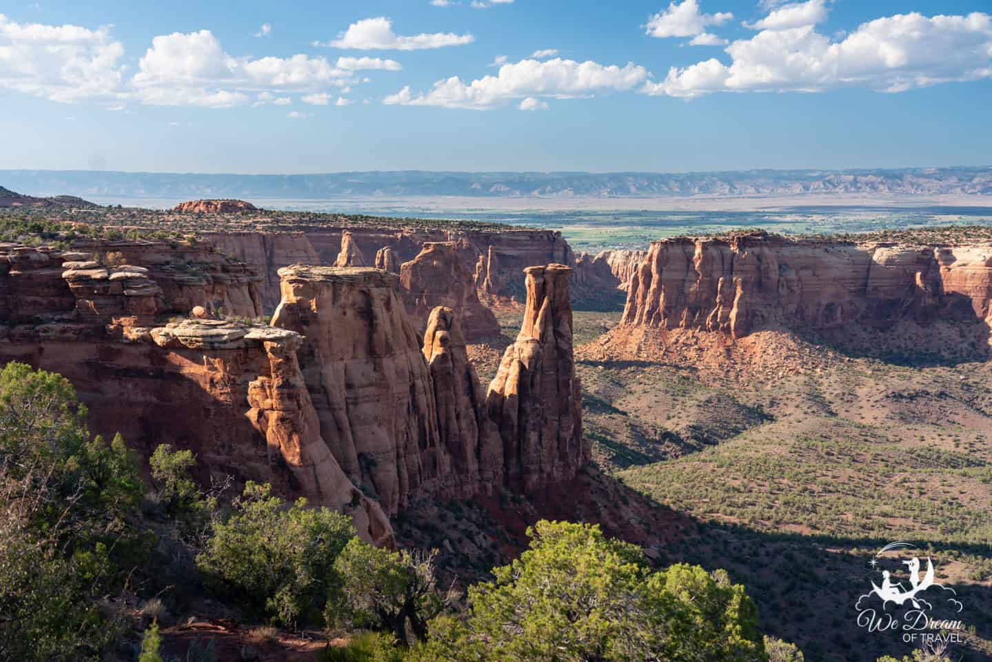 View from Rim Rock Drive between Grand View and Monument Canyon, overlooking towering rock formations.