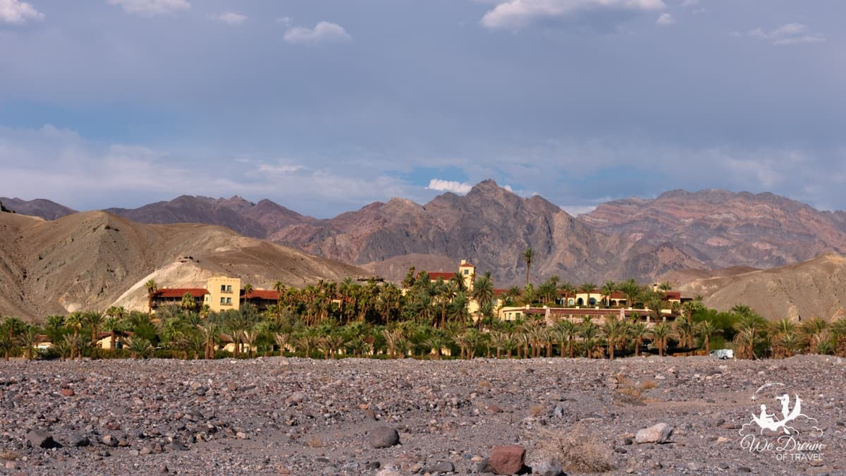 Panoramic photograph showing the tropical palm trees of the Oasis at Furnace Creek.