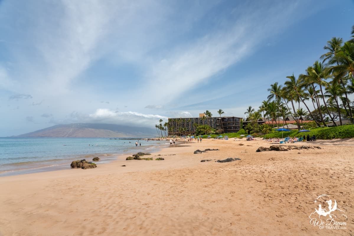 Sandy beach with turquoise waters and West Maui mountains in the background at Keawakapu Beach, one of Kihei's best beaches.