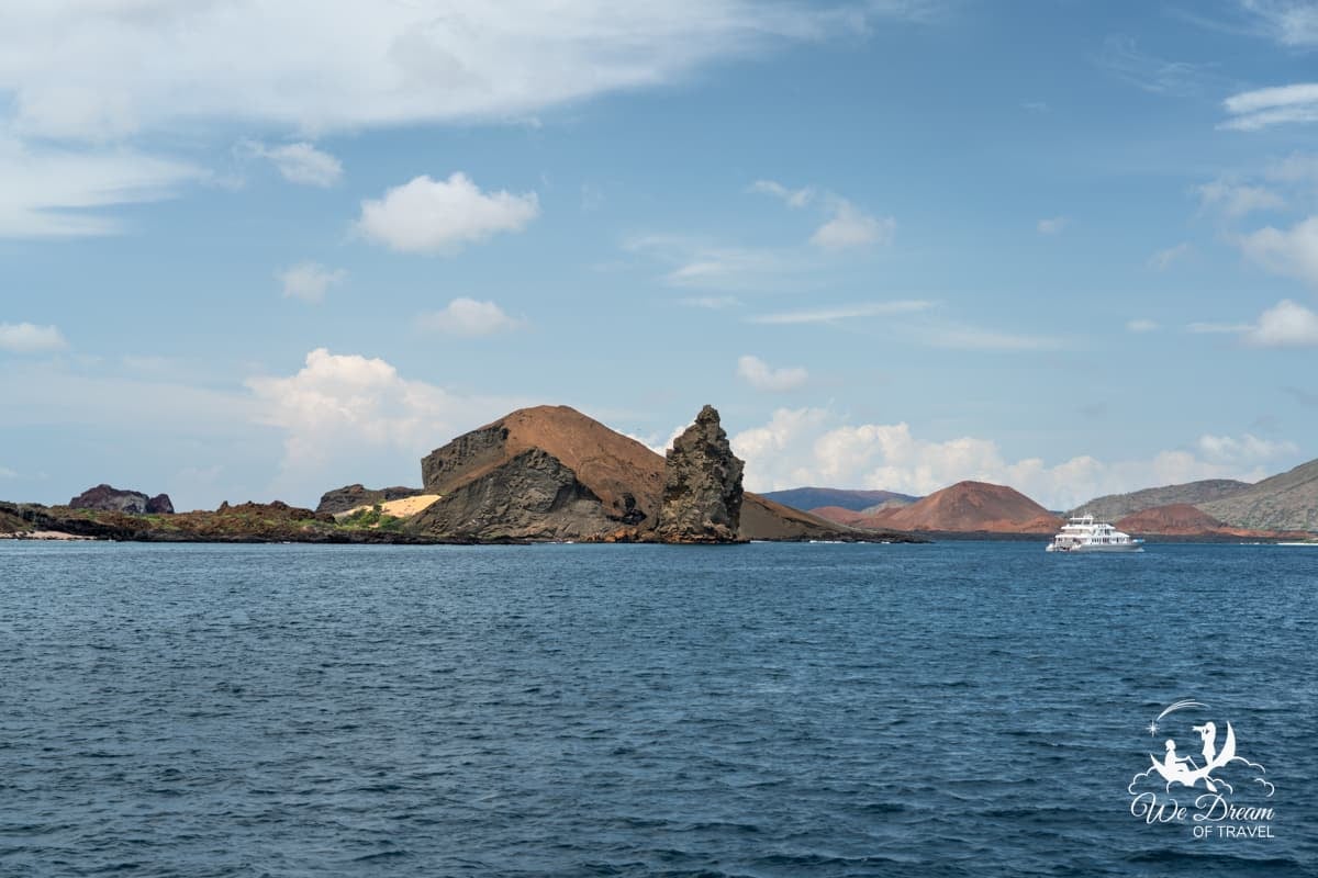 Pinnacle Rock, Bartolome Island, with a cruise ship anchored nearby.